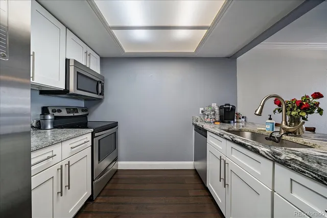 a kitchen with stainless steel appliances granite countertop a sink stove and cabinets