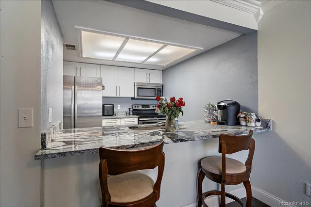a kitchen with kitchen island a stove and a refrigerator