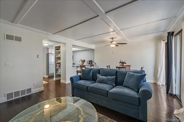 a living room with furniture and wooden floor