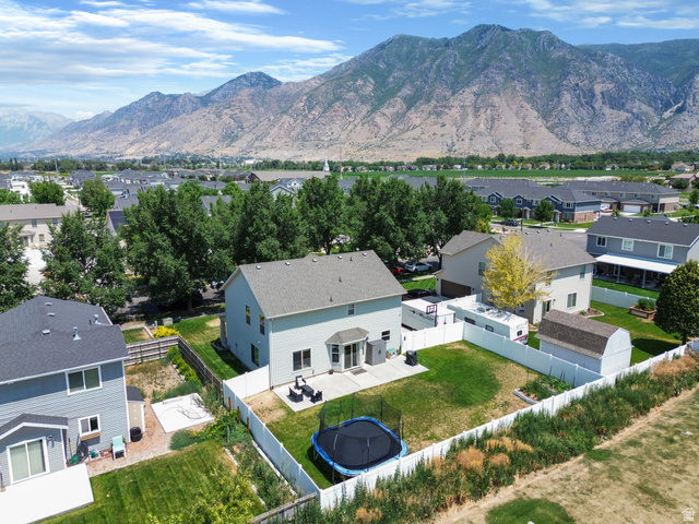1393 West 150 North Springville, UT 84663 - Photo 28 of 31 Expansive backyard featuring a green lawn, concrete patio, and white privacy fencing