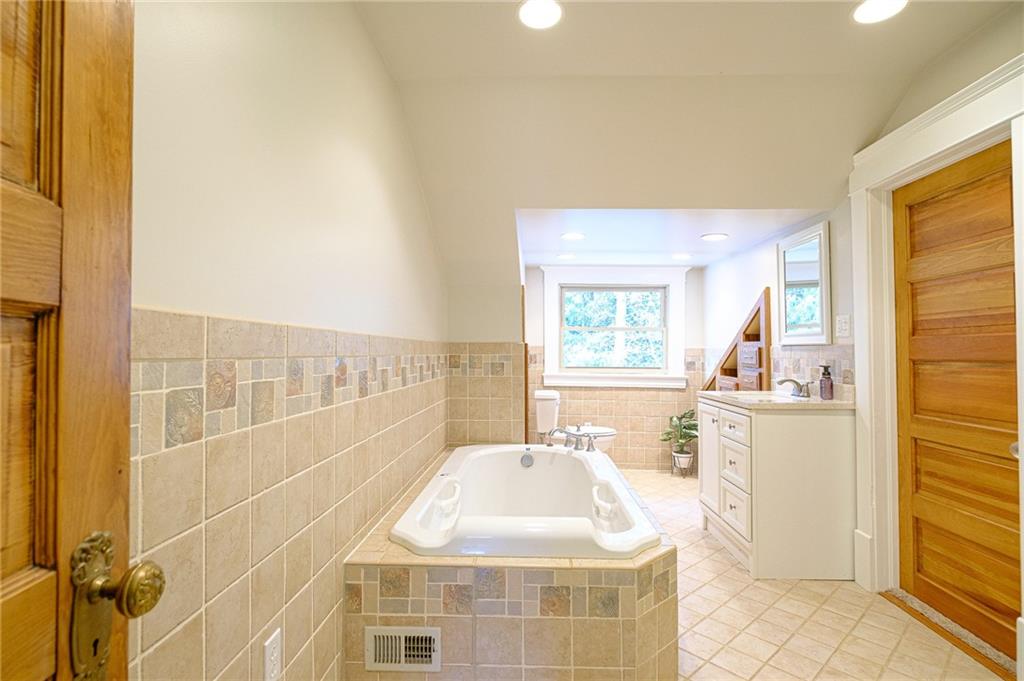437 Three Degree Road Butler, PA 16002 - Photo 16 of 25 a bathroom with a sink mirror and a shower