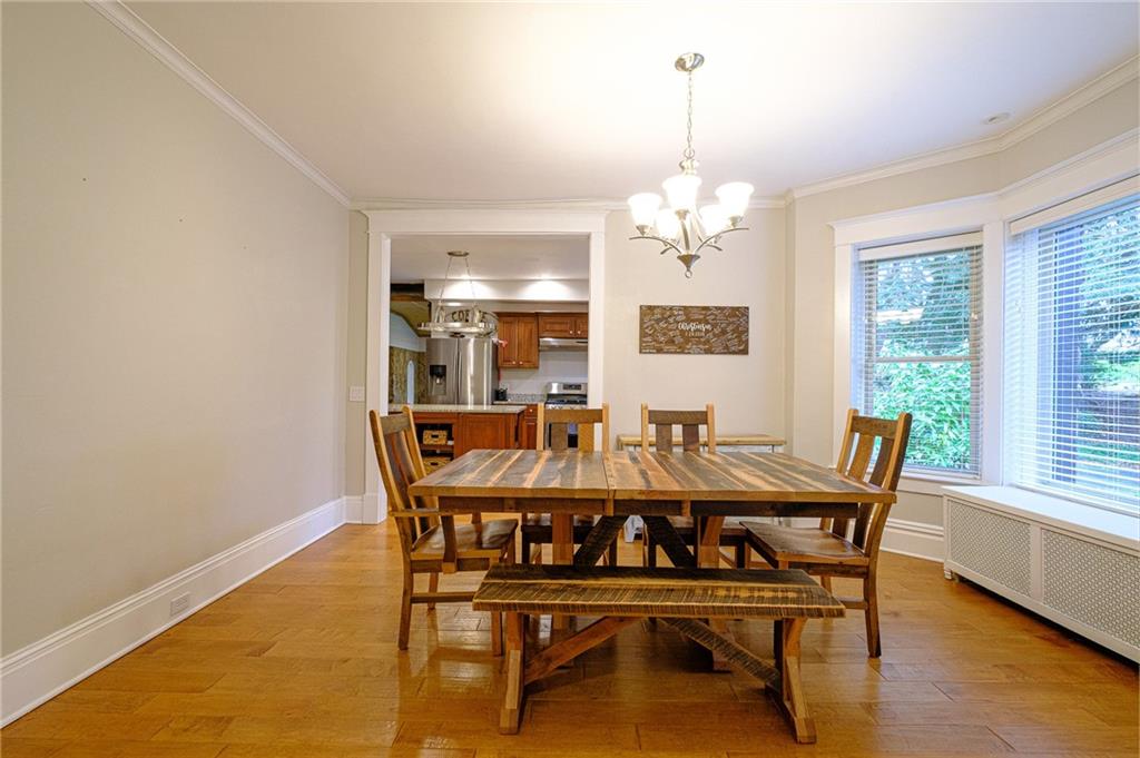 437 Three Degree Road Butler, PA 16002 - Photo 7 of 25 a dining room with furniture a chandelier and wooden floor