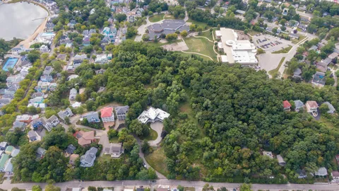 an aerial view of a house with a yard and outdoor seating