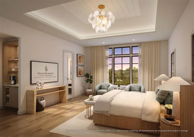 a spacious bedroom with a bed and a chandelier