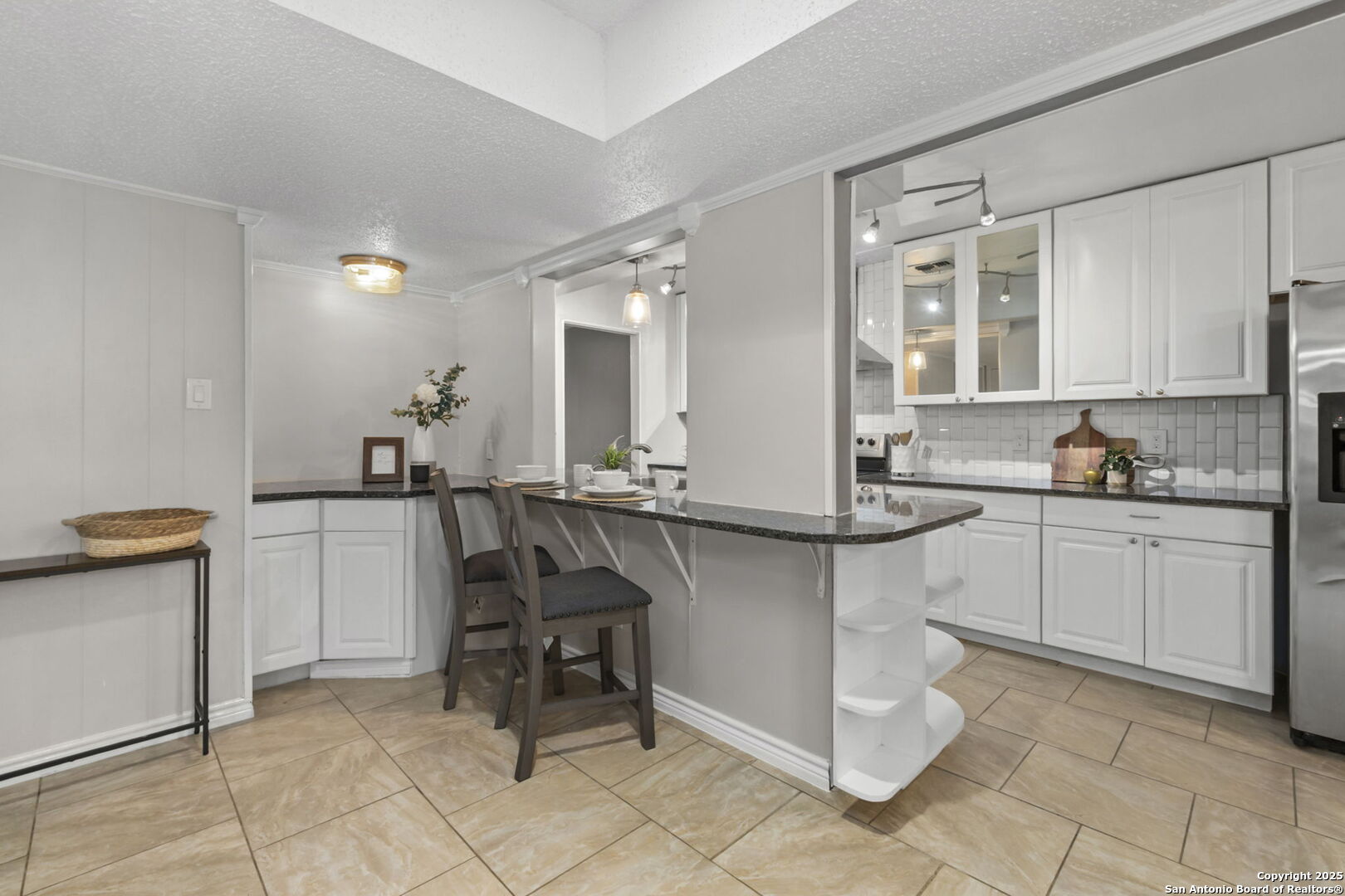 5203 Metcalf Windcrest, TX 78239 - Photo 13 of 37 a kitchen with a sink and chairs