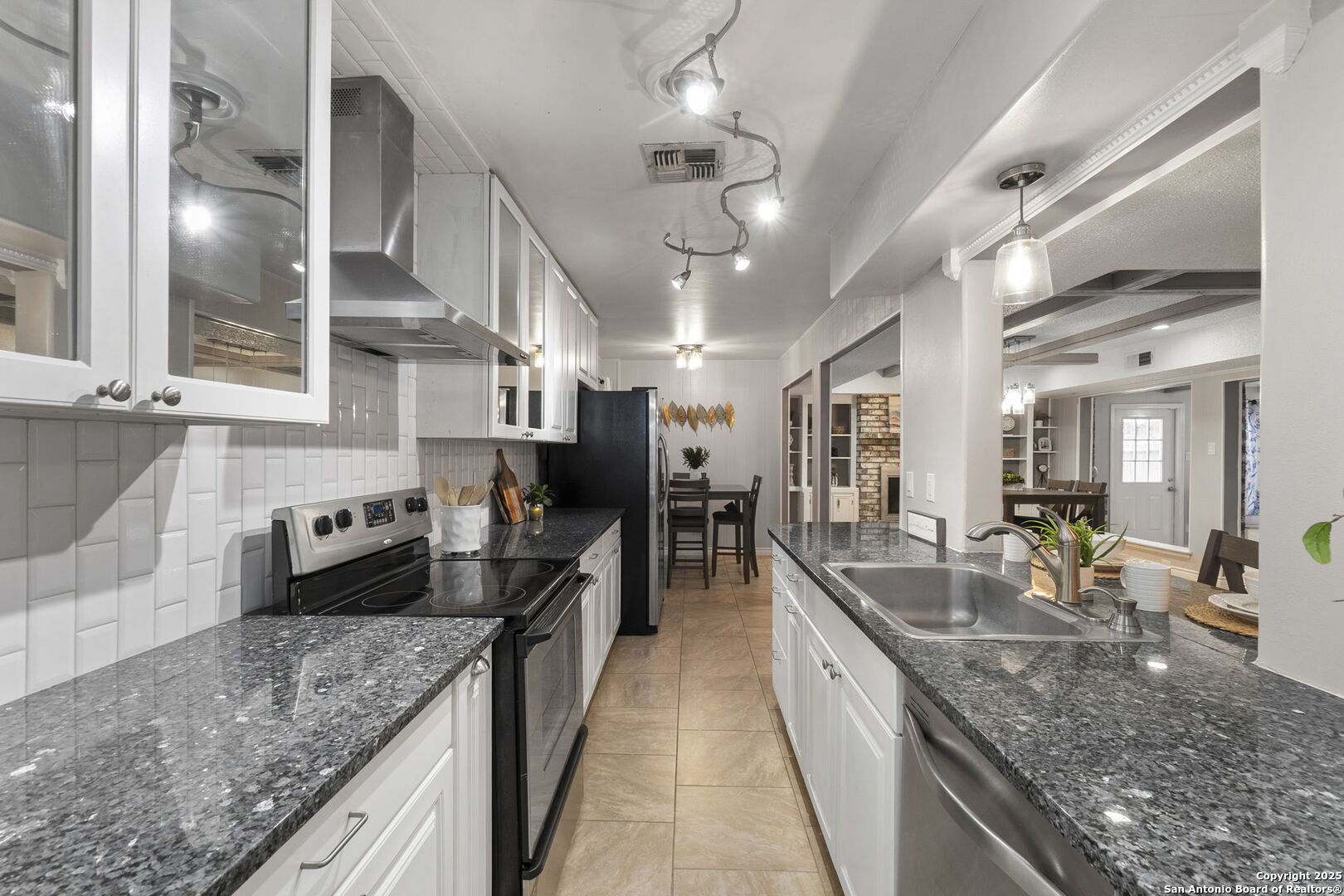 5203 Metcalf Windcrest, TX 78239 - Photo 14 of 37 a kitchen with stainless steel appliances granite countertop a sink a counter space a stove and a wooden floors