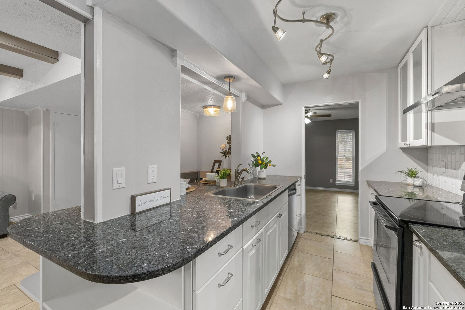 5203 Metcalf Windcrest, TX 78239 - Photo 16 of 37 a kitchen with stainless steel appliances granite countertop a sink and a refrigerator