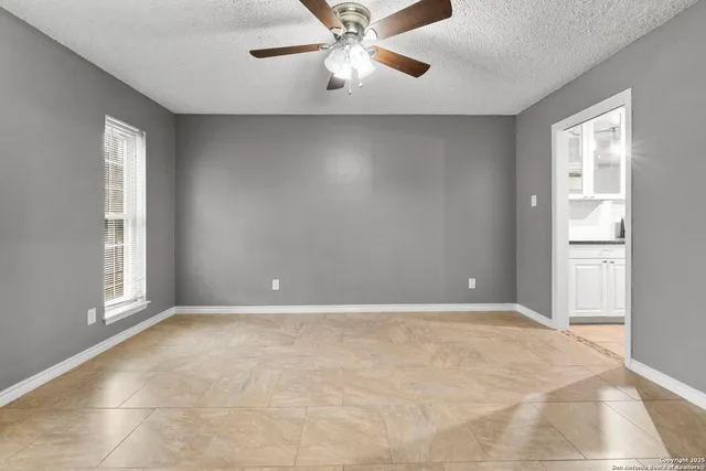 a view of a livingroom with workspace and a window
