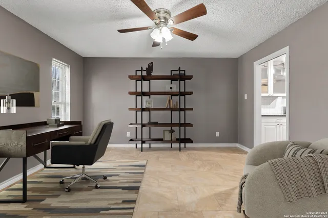 an empty room with closet and a ceiling fan