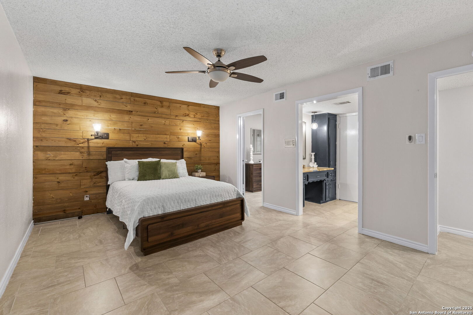 5203 Metcalf Windcrest, TX 78239 - Photo 20 of 37 a spacious bedroom with a bed and a chandelier