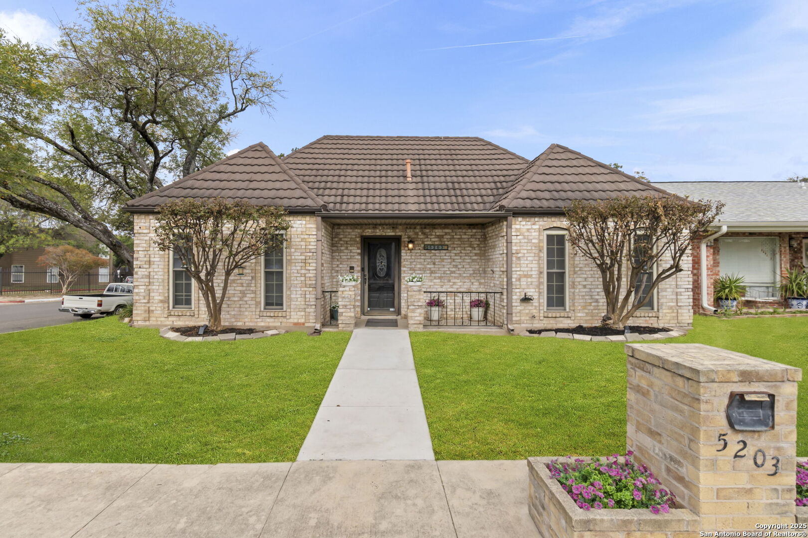 5203 Metcalf Windcrest, TX 78239 - Photo 2 of 37 a front view of a house with garden