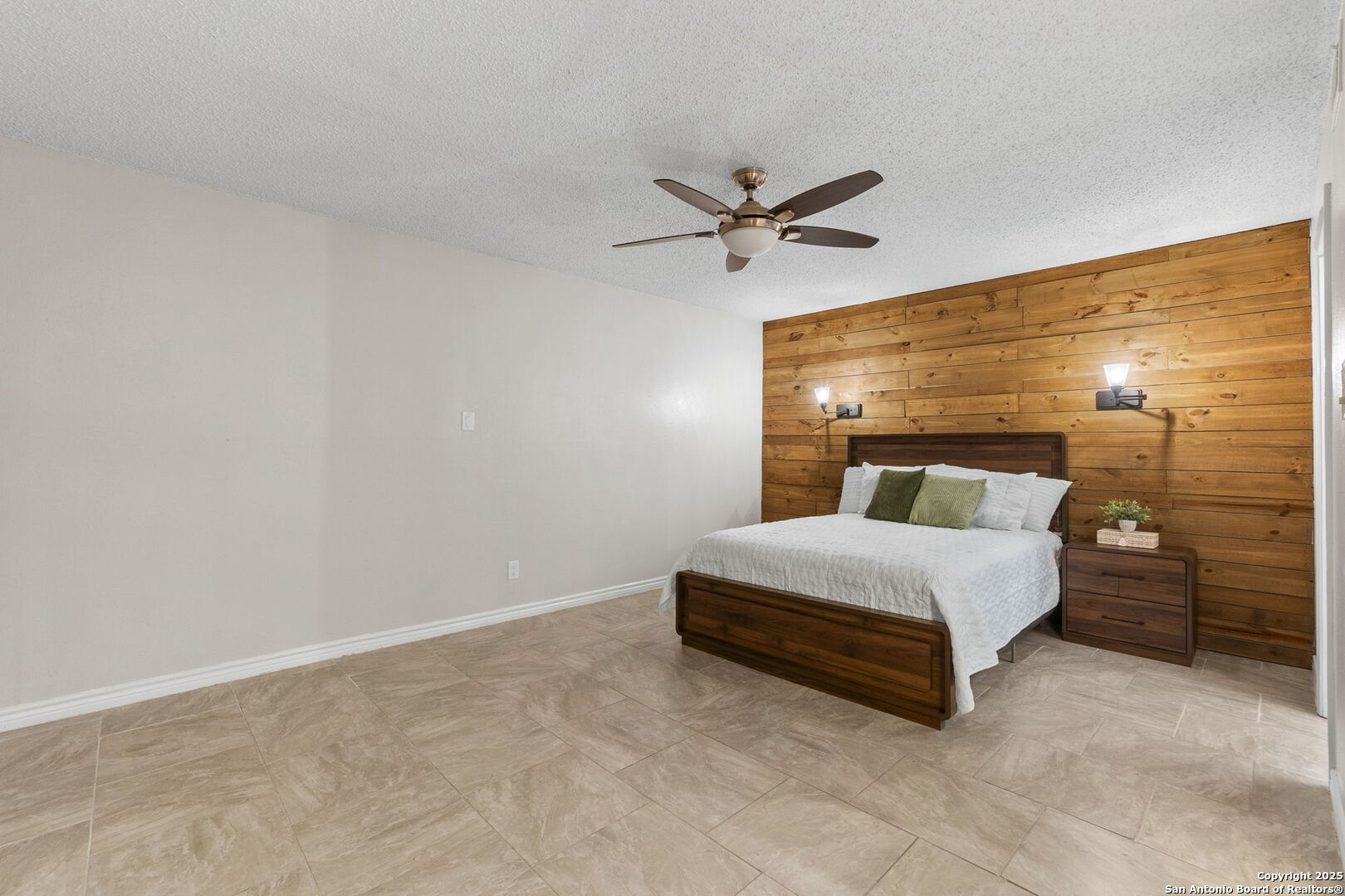 5203 Metcalf Windcrest, TX 78239 - Photo 21 of 37 a spacious bedroom with a bed and cabinet