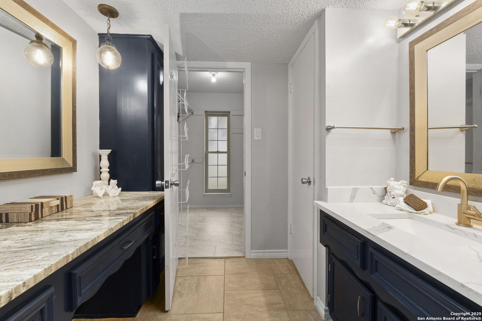 5203 Metcalf Windcrest, TX 78239 - Photo 22 of 37 a bathroom with a sink double vanity and a mirror