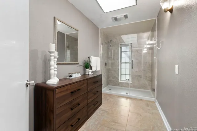 a view of staircase with lots of frames on wall and a chandelier