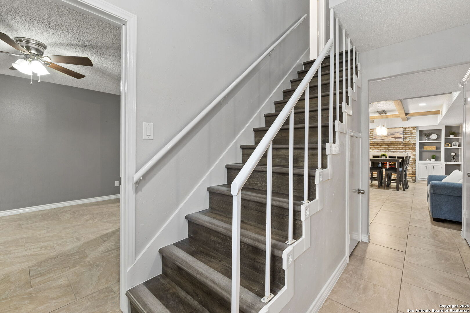 5203 Metcalf Windcrest, TX 78239 - Photo 25 of 37 a view of staircase with lots of frames on wall and a chandelier