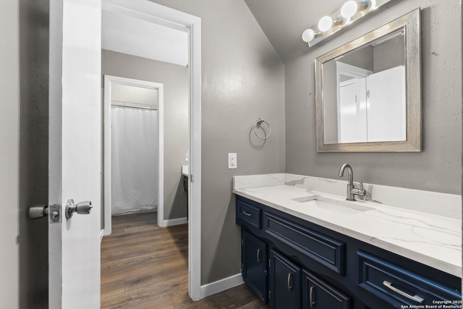 5203 Metcalf Windcrest, TX 78239 - Photo 28 of 36 a bathroom with a sink a vanity and a mirror
