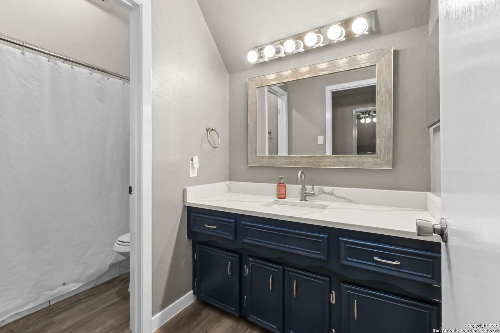 5203 Metcalf Windcrest, TX 78239 - Photo 29 of 36 a bathroom with a sink and a mirror