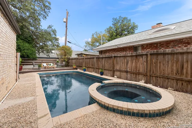 a patio with glass top table and chairs