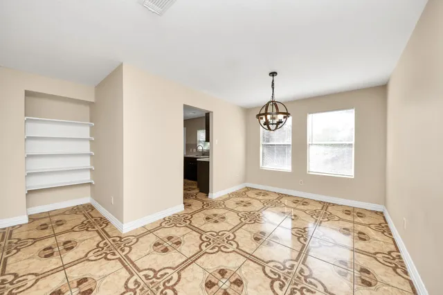 a view of a bedroom with wooden floor and windows