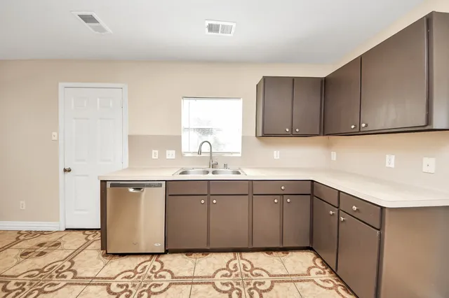 a kitchen with a sink and cabinets