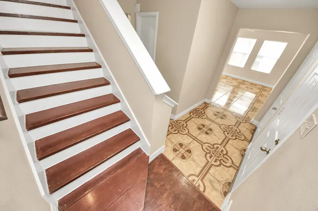 a view of staircase with wooden floor and stairs