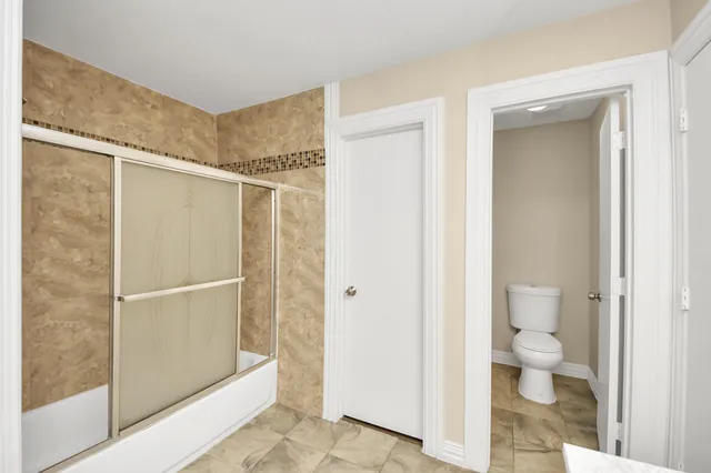 a spacious bathroom with a sink double vanity and a mirror