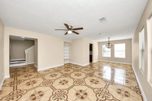 a view of a livingroom with a window and wooden floor