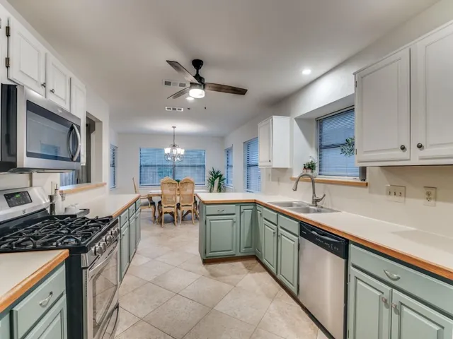 a kitchen with a sink stove and cabinets