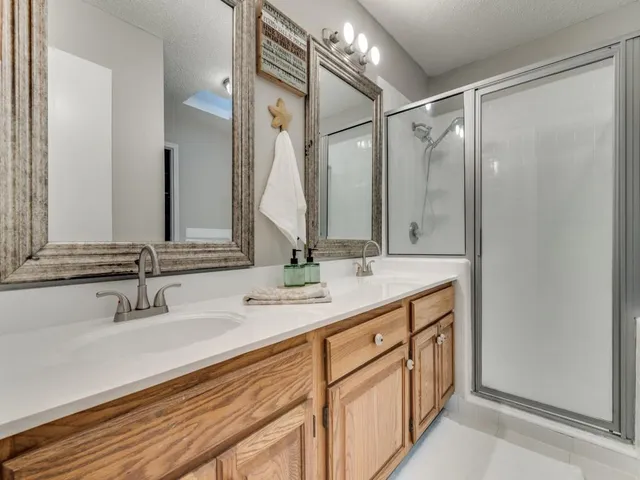 a bathroom with double vanity sink and a mirror