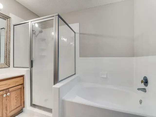 a bathroom with a bathtub and a shower