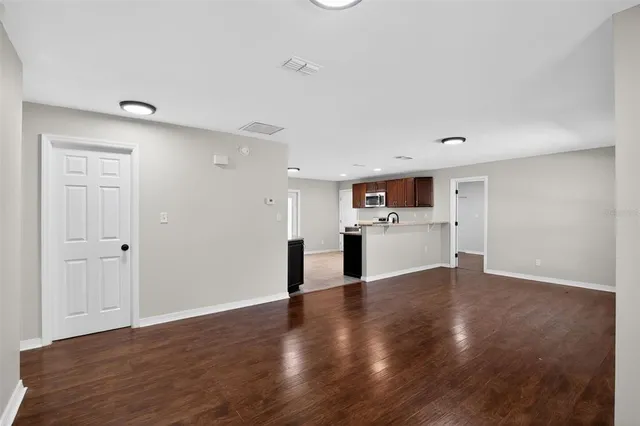 a view of a kitchen with a sink and a refrigerator