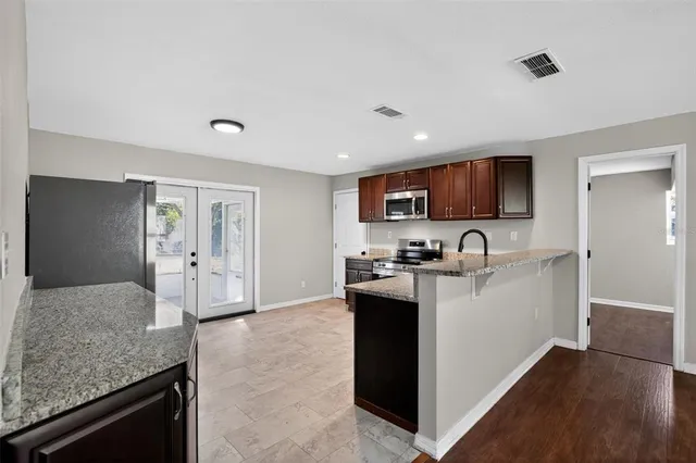 a view of kitchen with sink microwave and refrigerator