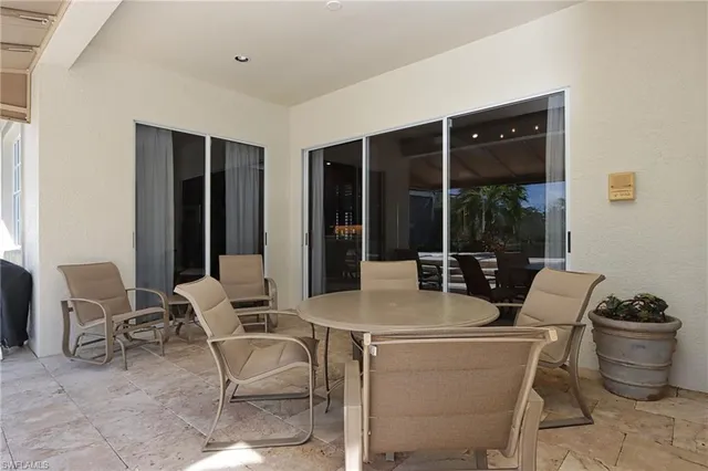 a dining room with furniture and a potted plant