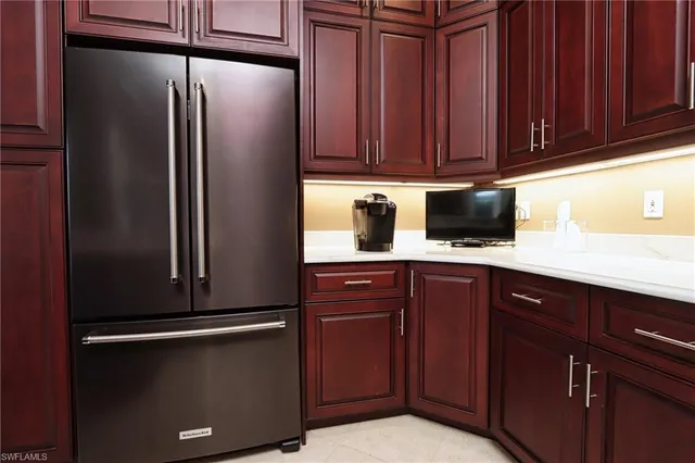 a kitchen with stainless steel appliances granite countertop a refrigerator and cabinets