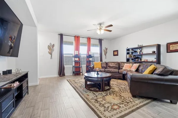 a living room with fireplace furniture and a rug