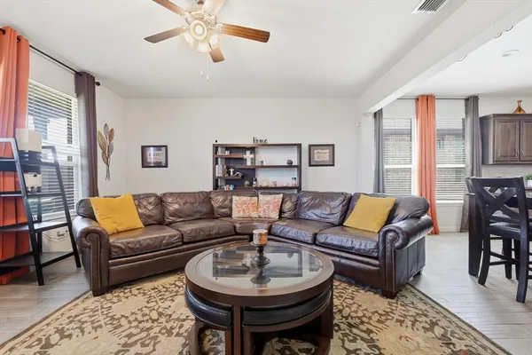 a living room with furniture a rug and a large window