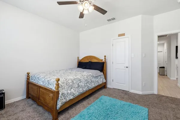 a bedroom with a bed and ceiling fan