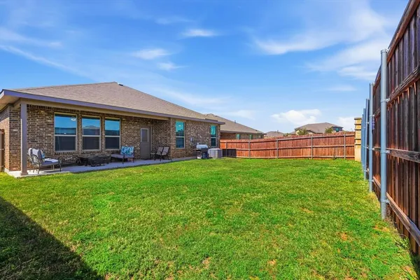 a view of a house with backyard porch and garden