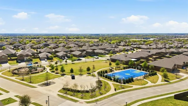 an aerial view of residential houses with outdoor space
