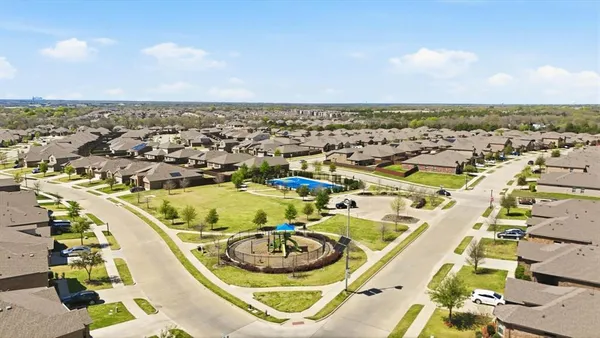 an aerial view of a residential houses with outdoor space