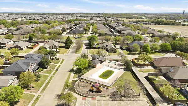 an aerial view of residential houses with outdoor space