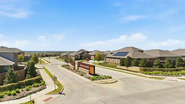 an aerial view of a house with a garden and lake view