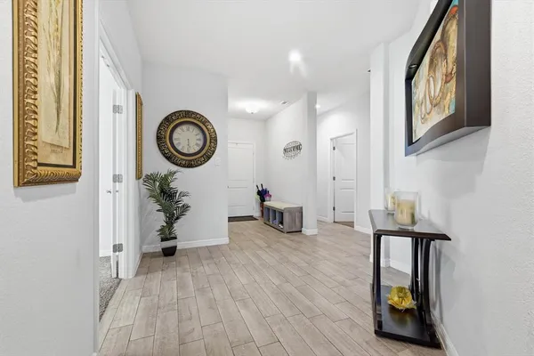 a view of an entryway with wooden floor