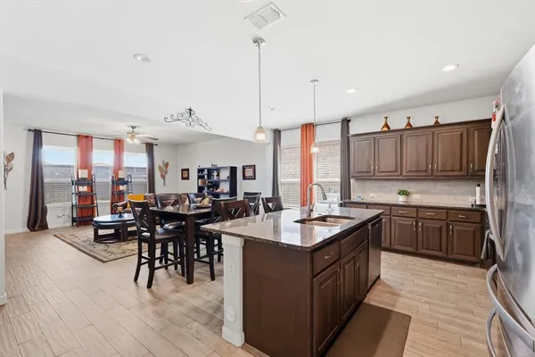 a kitchen with granite countertop a sink stove and cabinets
