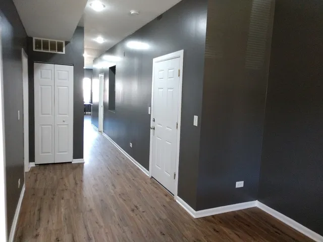 a view of hallway with wooden floor