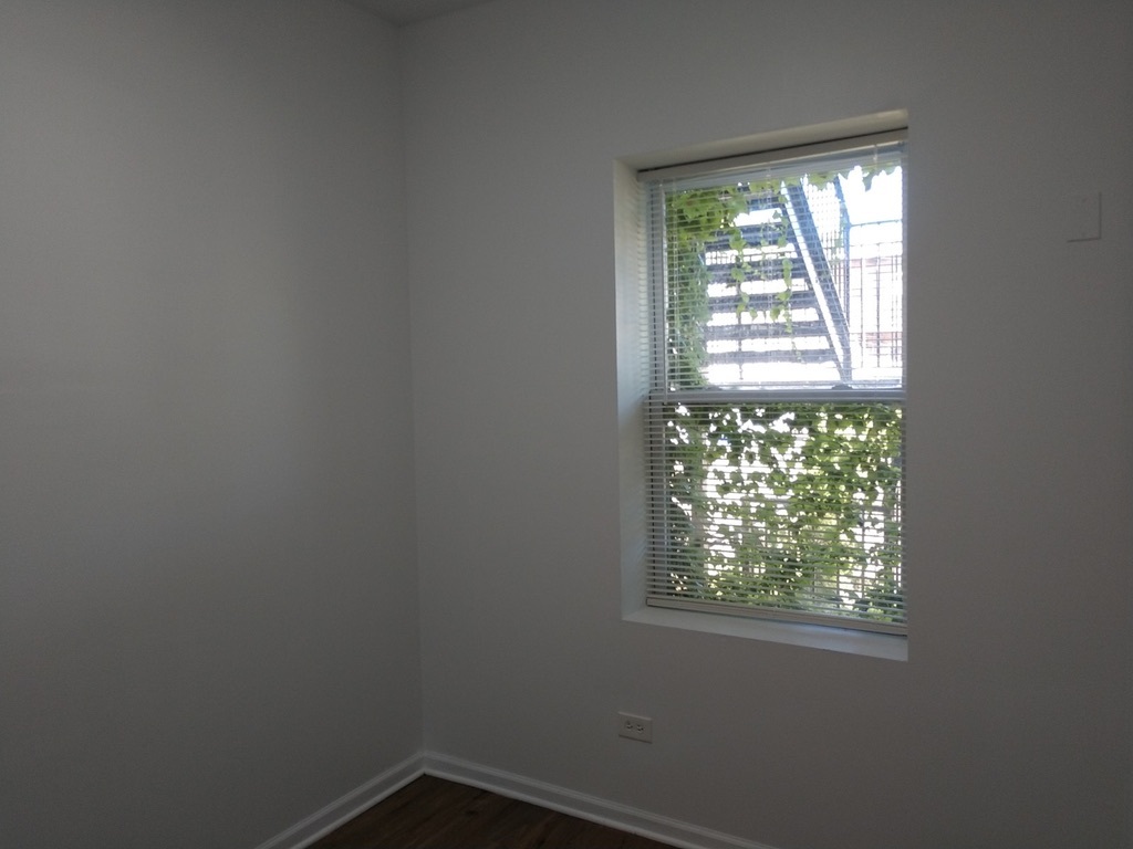 6219 South Rhodes Avenue Chicago, IL 60637 - Photo 16 of 24 an empty room with a window