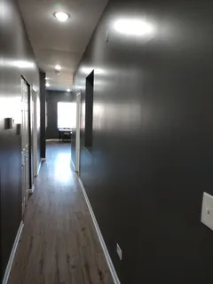 a view of gallery with wooden floor