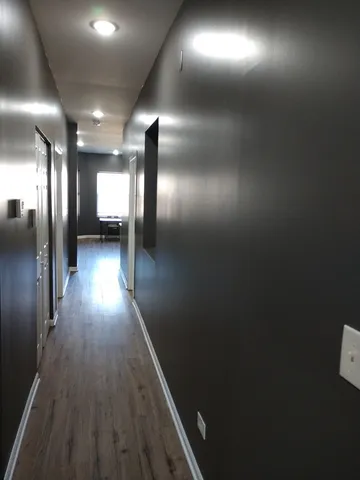 a view of gallery with wooden floor