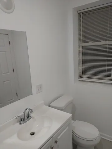 a bathroom with a sink toilet and vanity