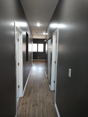 a view of gallery with wooden floor